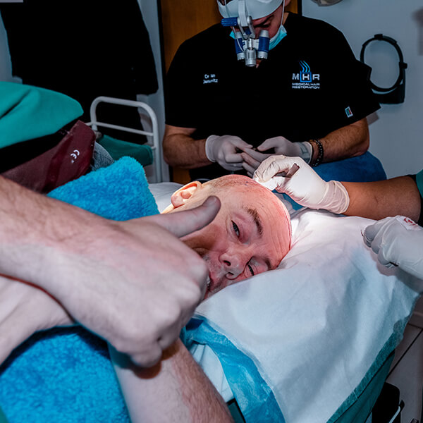 Dr Ryan Jankelowitz Cape Town Hair Surgeon Dr Ryan Jankelowitz in Cape Town performing FUE hair transplant surgery